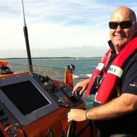 Mark at helm of a life boat